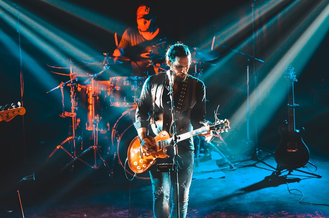 Uruguayan musician performing on a retro concert stage with dramatic lighting
